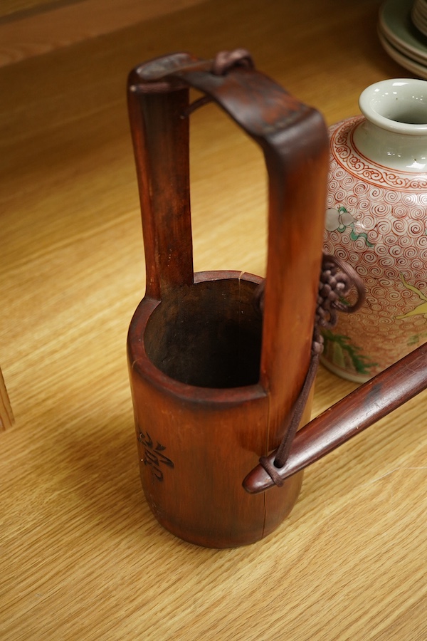 A Chinese famille rose jardiniere and bamboo oak rail, famille rose jardiniere 27cm diameter. Condition - jardiniere cracked from rim and restored, bamboo side cracked